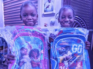 Children with school bags smiling